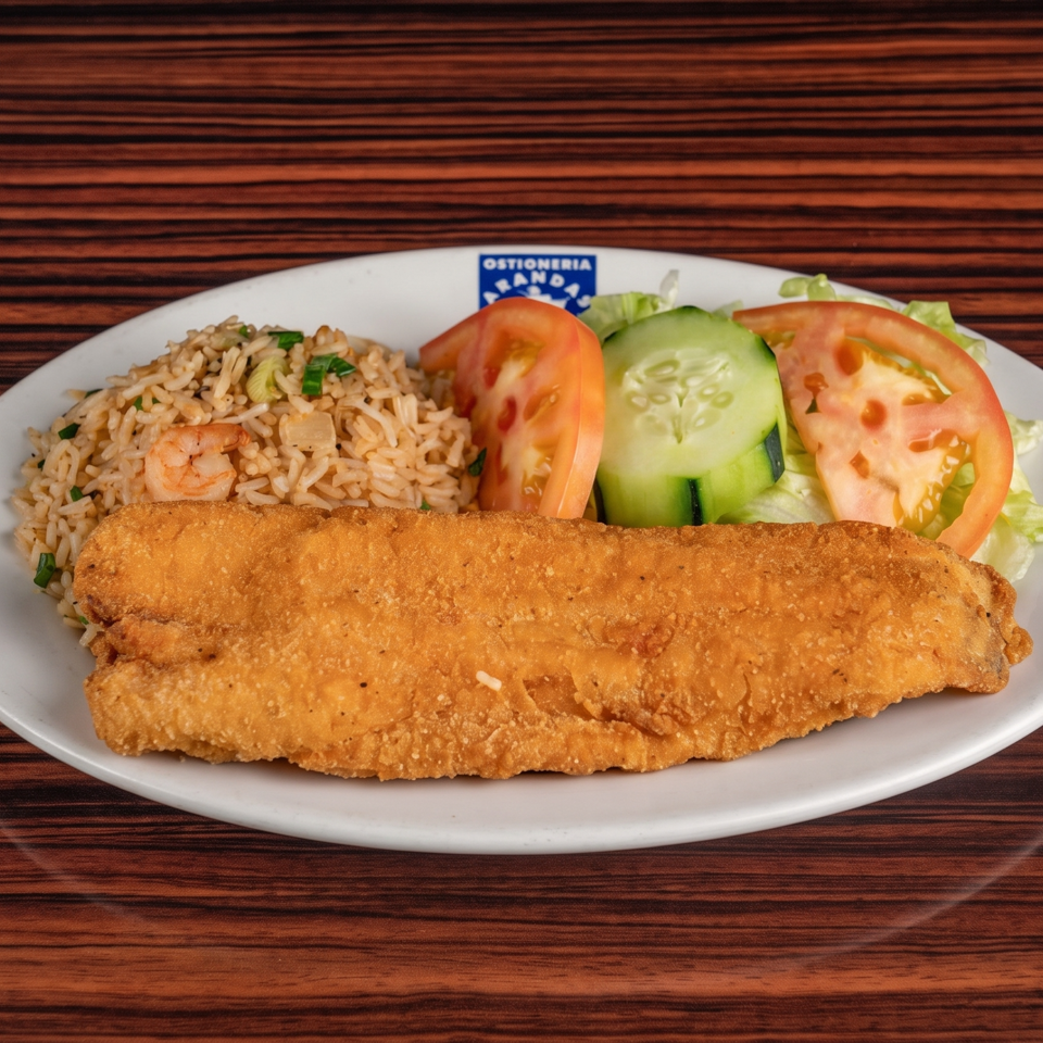 Fried fish fillet with shrimp fried rice, lettuce, tomato, and cucumber on a white plate.